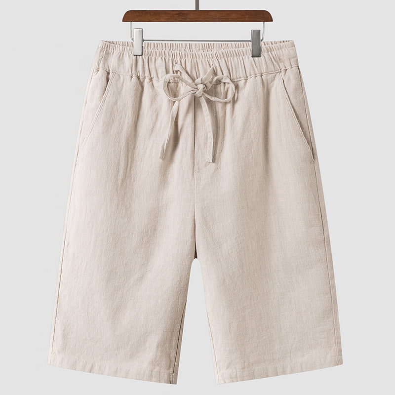 Men's casual loose cropped linen shorts in light beige with elastic waist and drawstring