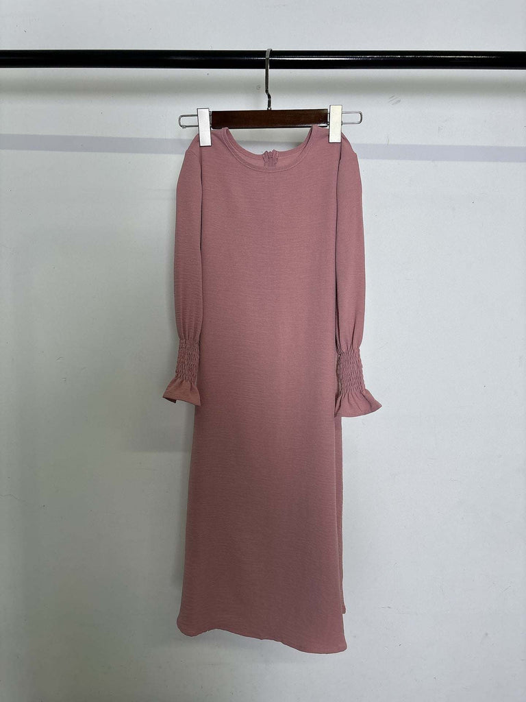 Pink round neck wavy ruffled long sleeve polyester dress for girls hanging on hanger