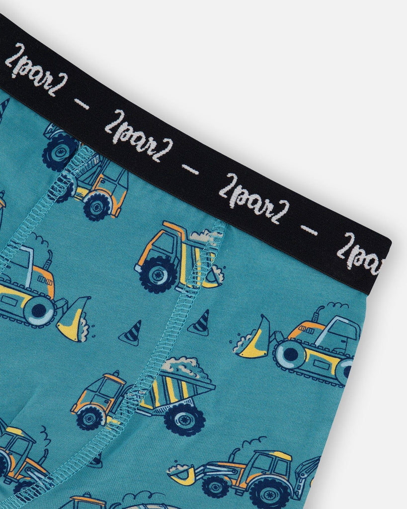 Printed organic cotton boxer shorts in teal with yellow truck print and black logo elastic waistband