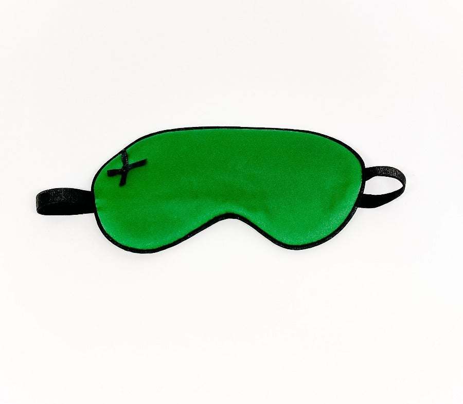 green satin sleep mask with black trim and elastic strap for comfortable sleep
