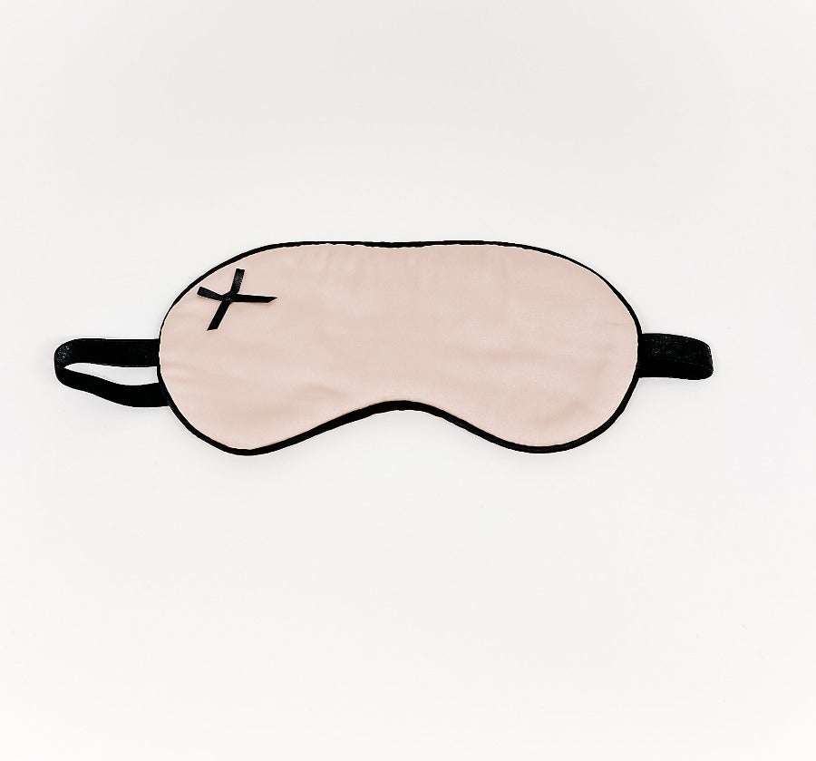 Satin sleep mask in beige with black trim and strap for comfortable light blocking