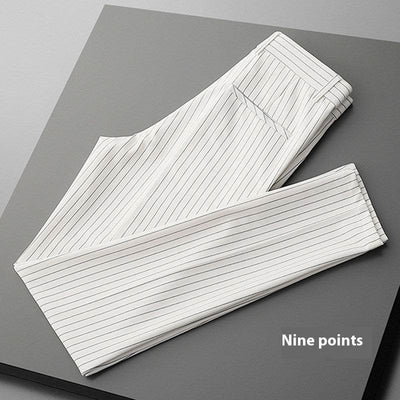 White thin casual striped men's loose draping suit pants folded on gray surface