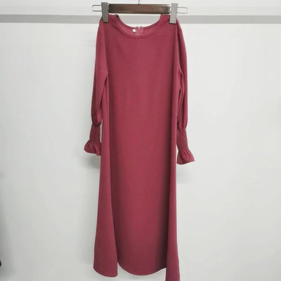 Round neck wavy ruffled long sleeve solid color polyester dress for kids hanging on hanger