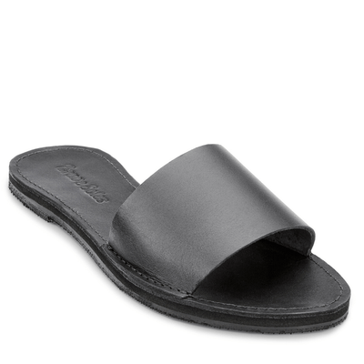 The Linda Leather Slide is a black handcrafted leather slide sandal with a cushy foam mid-sole and hand-cut sole from upcycled tires, designed for instant comfort and elegant style.