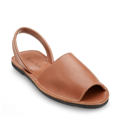 The Avarca Slide Sandal brown leather open-toe handcrafted sandal with ankle strap and upcycled tire sole
