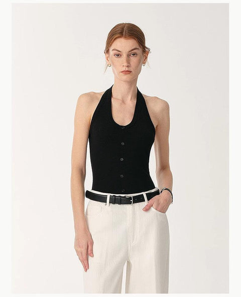 woman wearing black halter neck jumpsuit with front buttons and white pants German Yangzi 48S wool