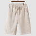 Men's casual loose cropped linen shorts in light beige with elastic waist and drawstring