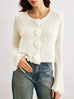 White slim fit knitwear with three-dimensional flower buttons and petal sleeves