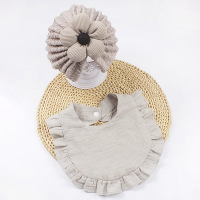 Newborn baby hat and muslin bib set with frilly trim in soft organic cotton