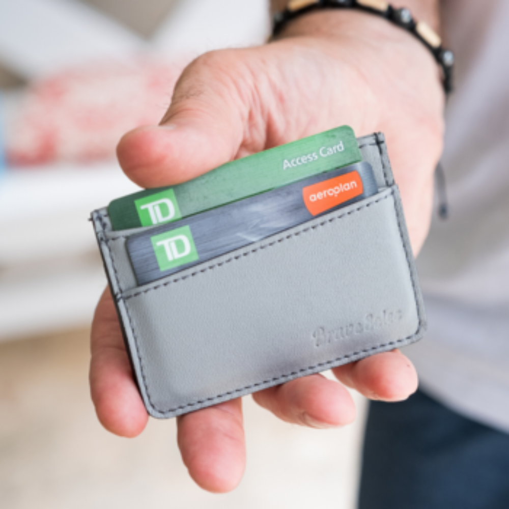 The Voyageur Card Holder made from upcycled reclaimed plane seats leather, holding cards and cash securely in a compact design