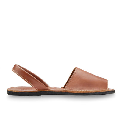 The Avarca Slide Sandal in brown leather with a peep toe and ankle strap, handcrafted with ethical leather and upcycled tire soles for comfort and durability