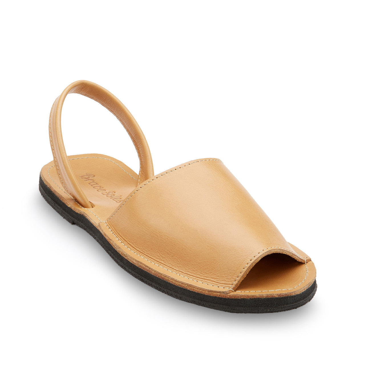 The Avarca Slide Sandal in tan leather with open toe, adjustable ankle strap, and black sole, handcrafted from ethically sourced materials for comfort and durability