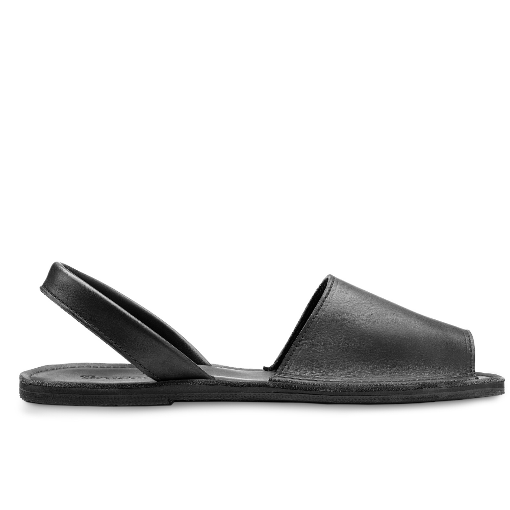 The Avarca Slide Sandal black leather open-toe handcrafted sandal with ankle strap and flat sole