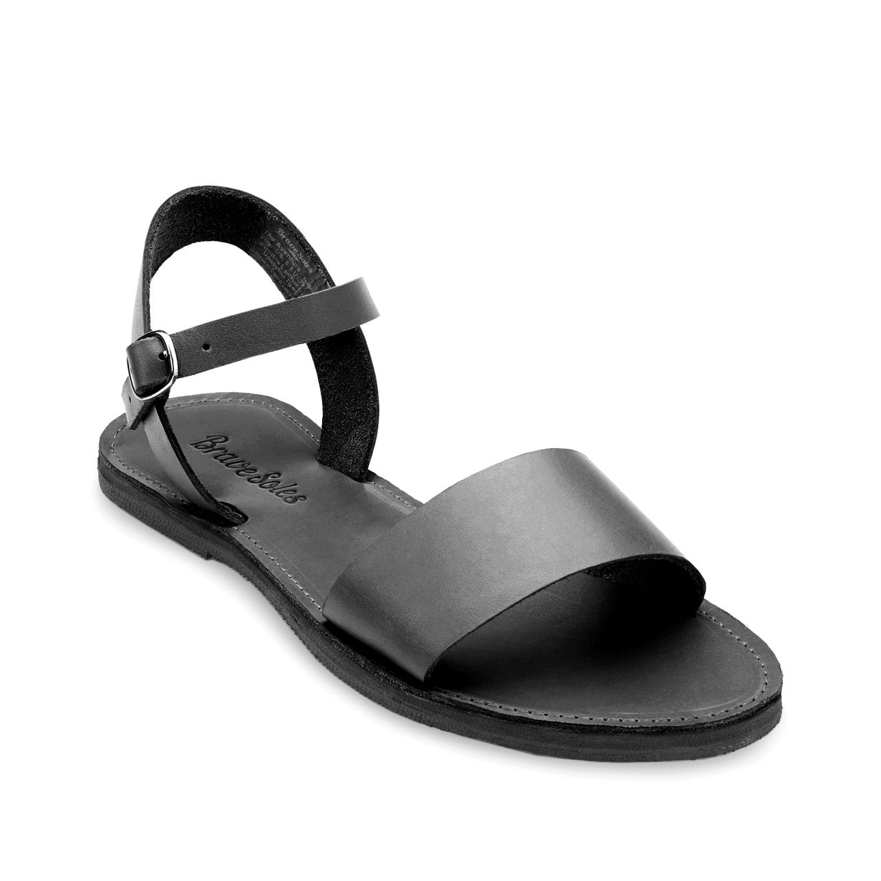 Black Aventura leather walking sandal with ankle strap and upcycled tire sole, handcrafted in the Dominican Republic for travel and comfort.