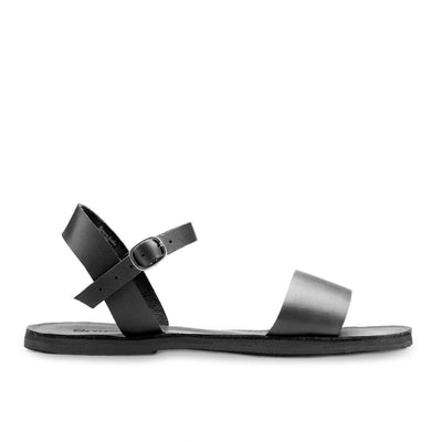 Black Aventura leather walking sandal with ankle strap and hand-cut upcycled tire sole, designed for comfort and support.