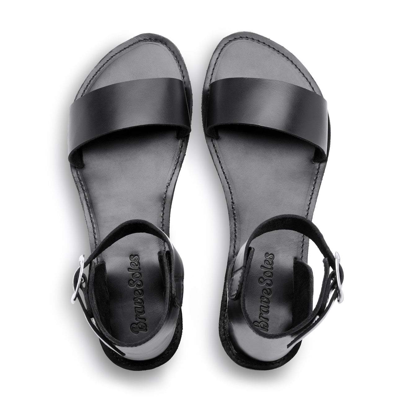 The Camila Leather black leather flatform sandals with ankle strap and cushy midsole, handcrafted with ethically sourced materials and upcycled tire soles.