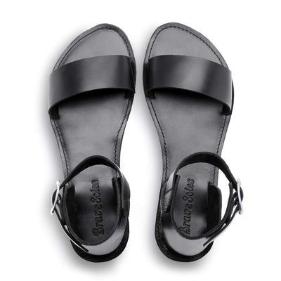 The Camila Leather black leather flatform sandals with ankle strap and cushy midsole, handcrafted with ethically sourced materials and upcycled tire soles.