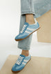 Peak Burn Casual Lace-Up Sneakers blue faux leather with white stripes and rubber sole worn with jeans