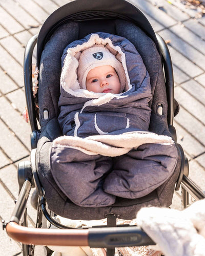 Baby wrapped in Snuggly Wrap Black with plush lining and animal ears in stroller car seat.