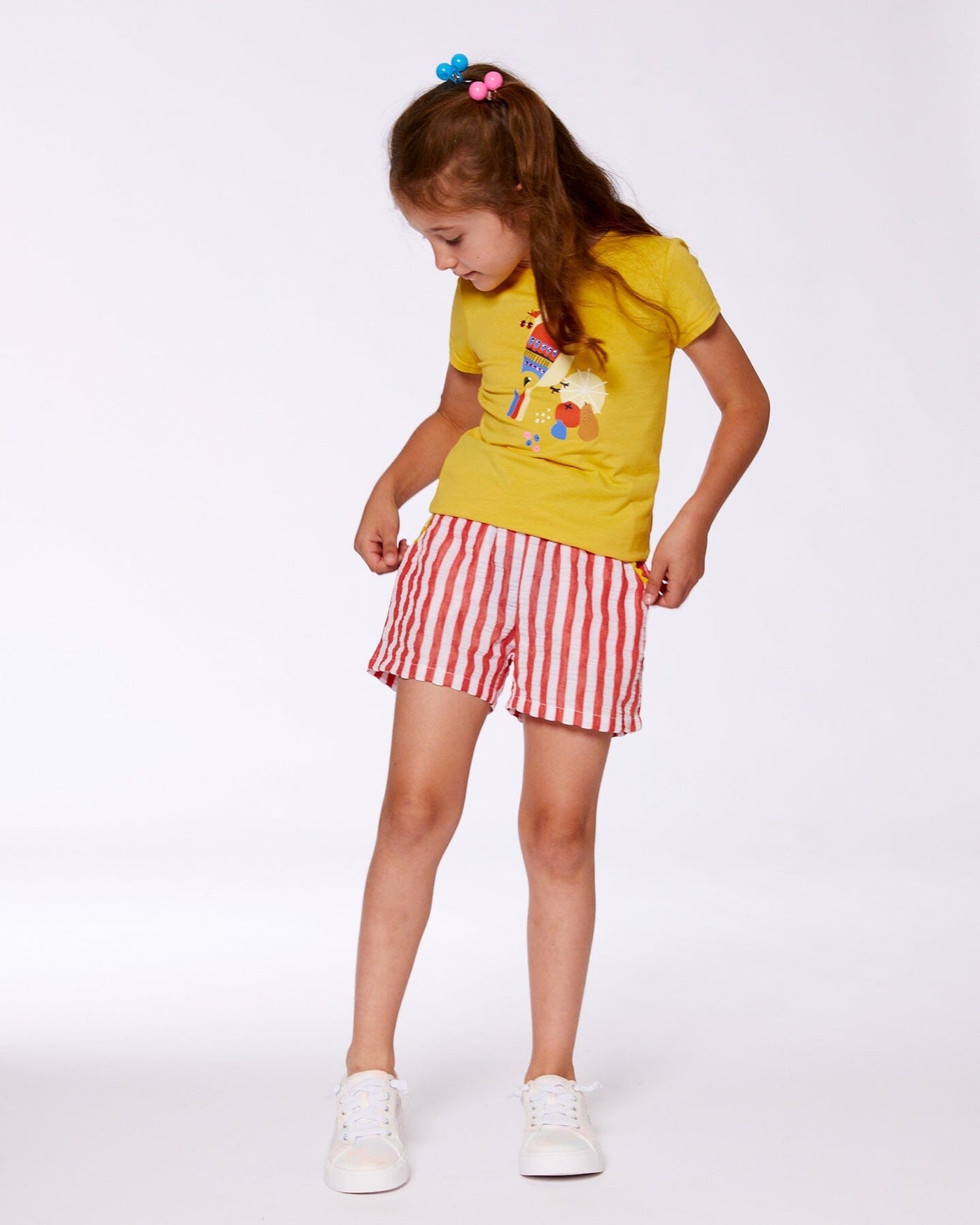 Girl wearing red and white striped Seersucker Short with elastic waistband and ricrac trim