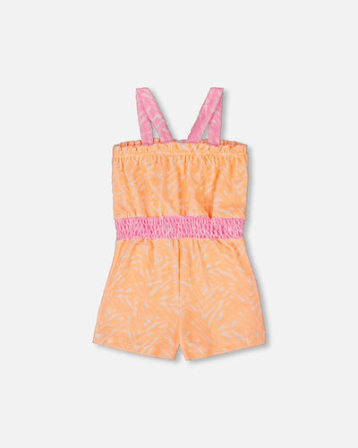 Printed terry cloth romper in vibrant orange and white with pink straps and elastic waistband
