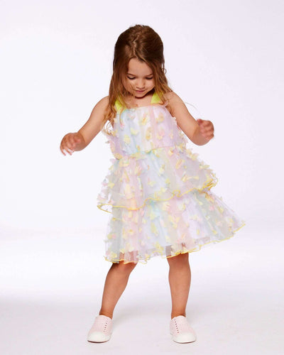 Little girl wearing a multicolored tiered printed mesh dress with butterfly appliques and wide straps