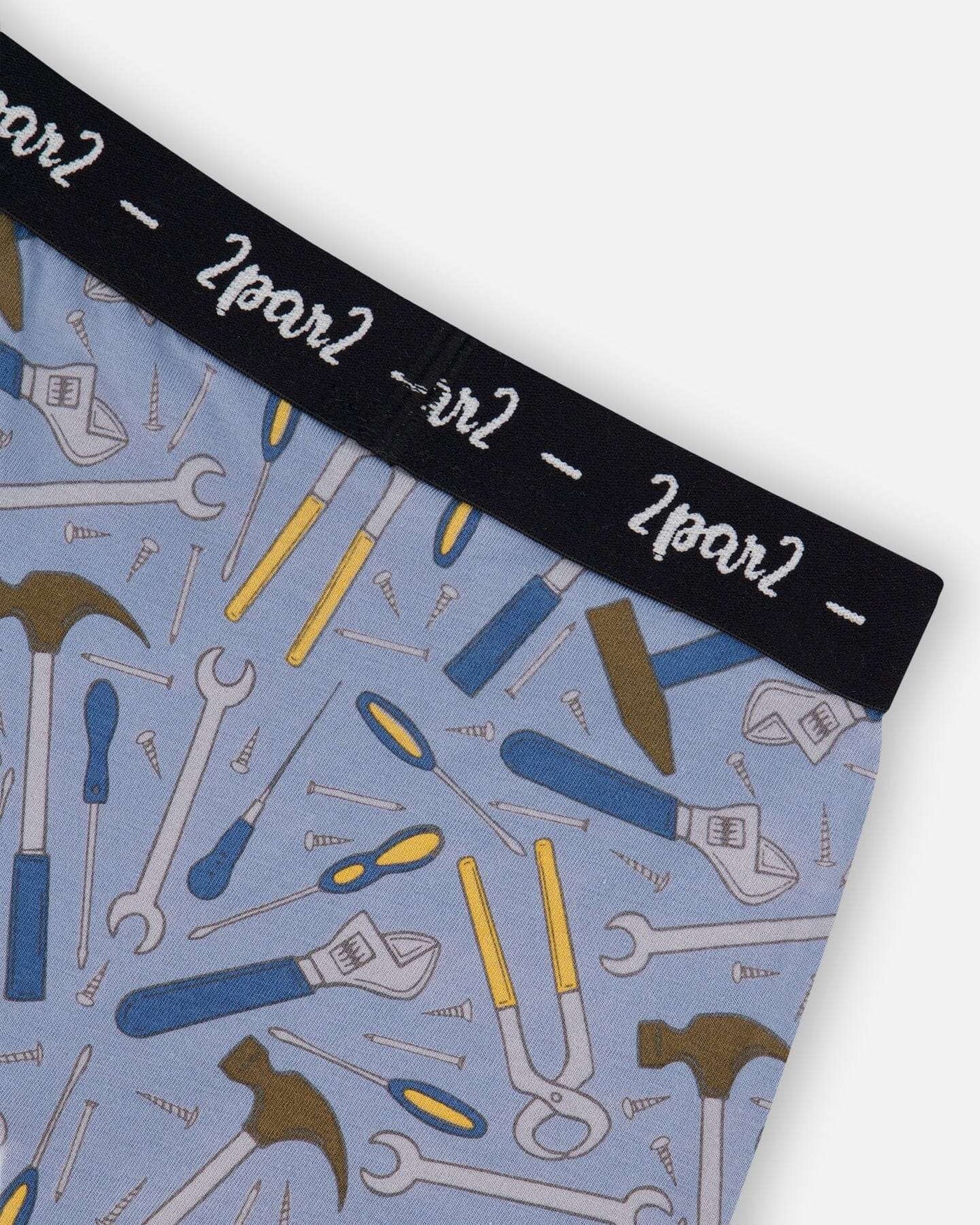 Printed organic cotton boxer shorts with colorful tool print on bluish gray background and black elastic waistband
