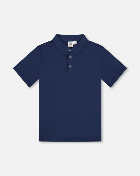 Navy blue short sleeve polo shirt with three button placket and soft knit collar in stretch cotton fabric