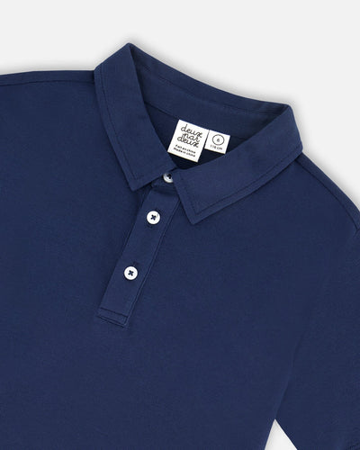 Navy blue short sleeve polo shirt with soft knit collar and three-button placket