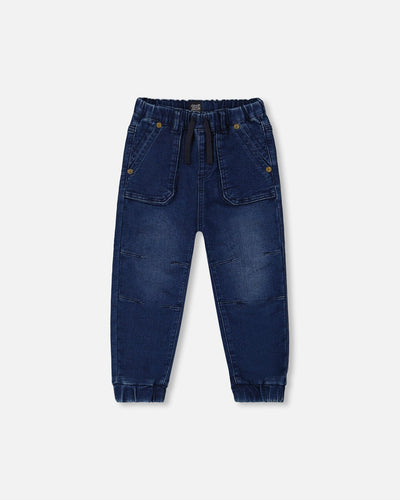 Dark denim French Terry Denim Jogger Pant with elastic ankles, darted knees, drawstring waistband, and front utility pockets