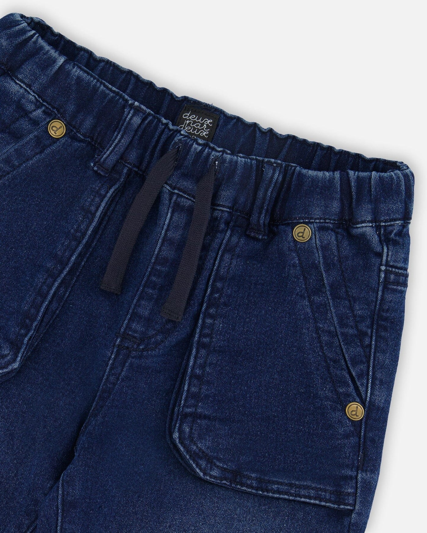 Dark denim blue French Terry Denim Jogger pants with elastic waistband, drawstring, front utility pockets, and logo rivets.