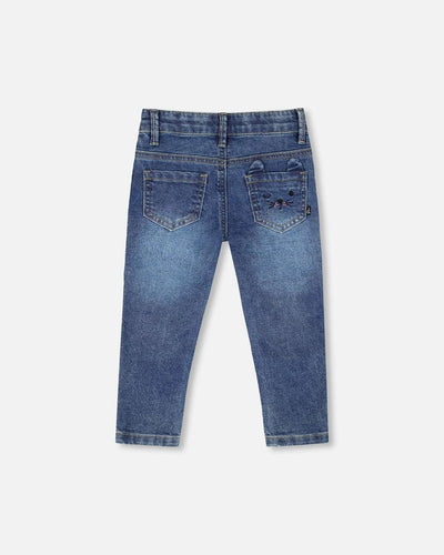 Back view of children's jeans blue denim with embroidered cat face on pocket and practical front and back pockets