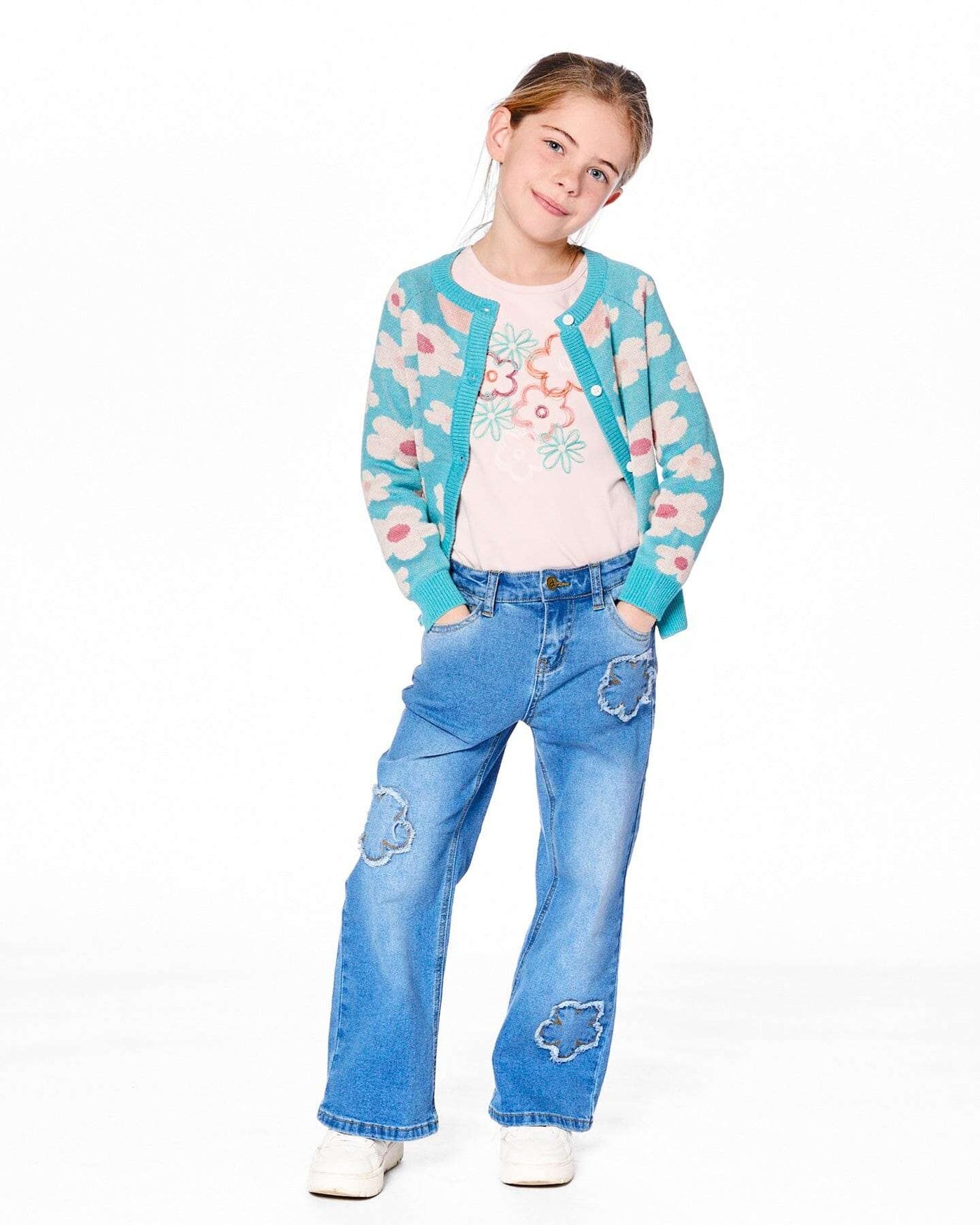 Girl wearing wide leg stretch light blue denim jeans with flower stitching and a blue floral cardigan
