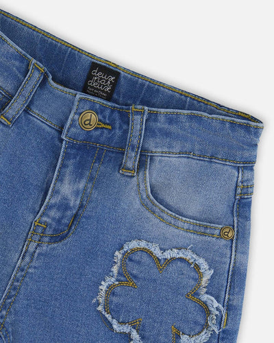 Wide leg stretch light blue denim jeans with flower stitching and front pockets