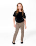 Young girl wearing jacquard knit pant with houndstooth pattern and black top