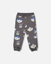 Gray fleece sweatpants with playful dog and ski gondola print, drawstring waist, side pockets, and ribbed cuffs
