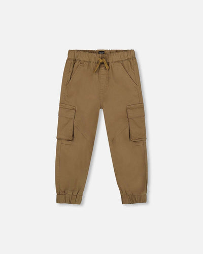 Twill jogger cargo pants in taupe with drawstring waist, elastic ankles, flap cargo pockets, and angled knee seams.