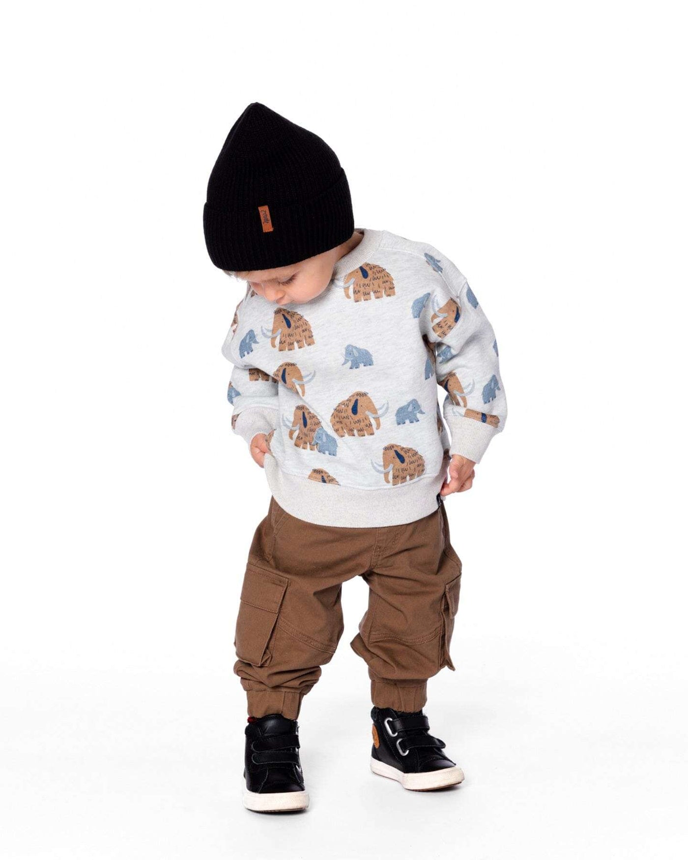 Toddler wearing taupe twill jogger cargo pants with flap pockets and elastic ankles paired with a bear print sweatshirt and black beanie