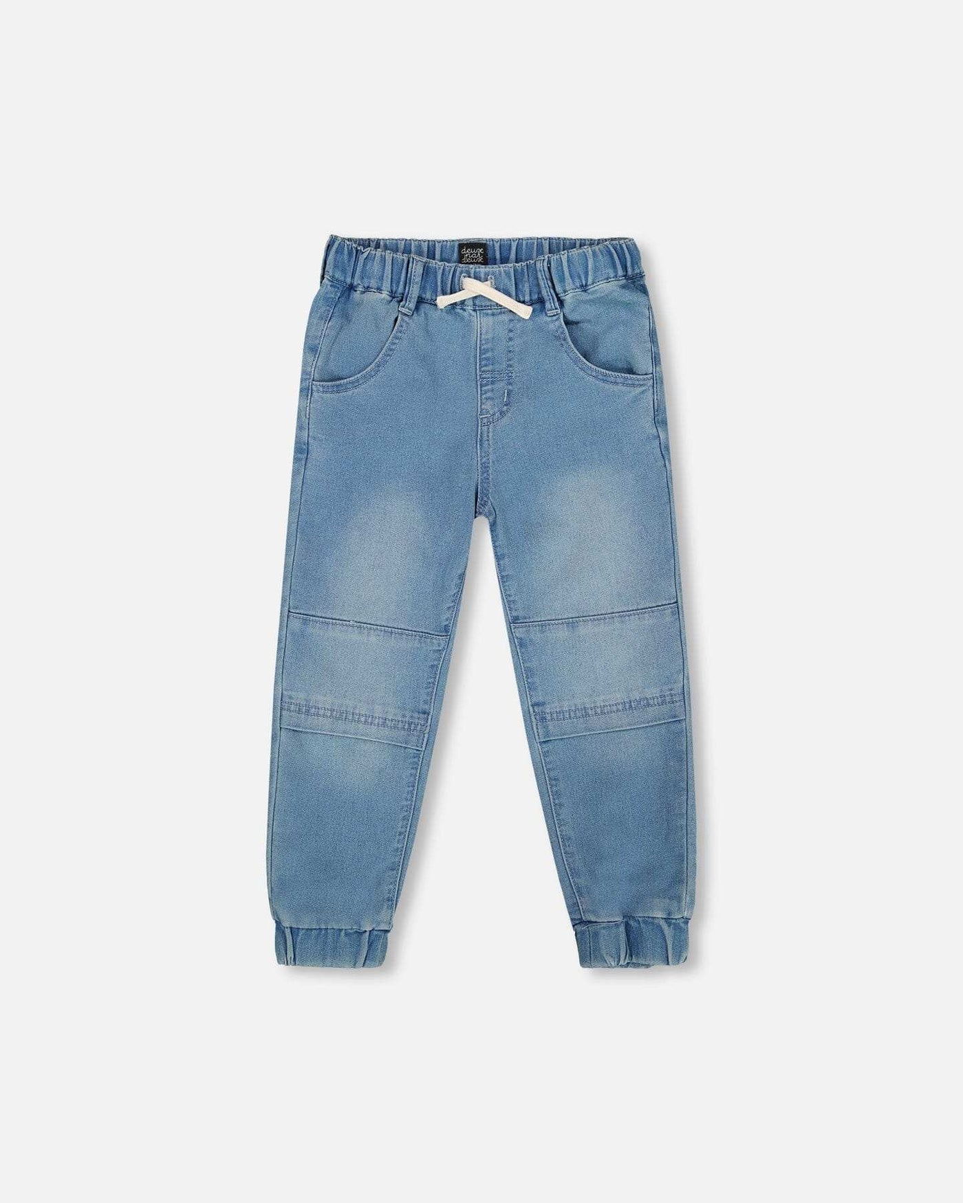 Light blue denim French Terry jogger pants with drawstring waistband, seamed knee panels, scoop front pockets, and elastic ankles for comfort.
