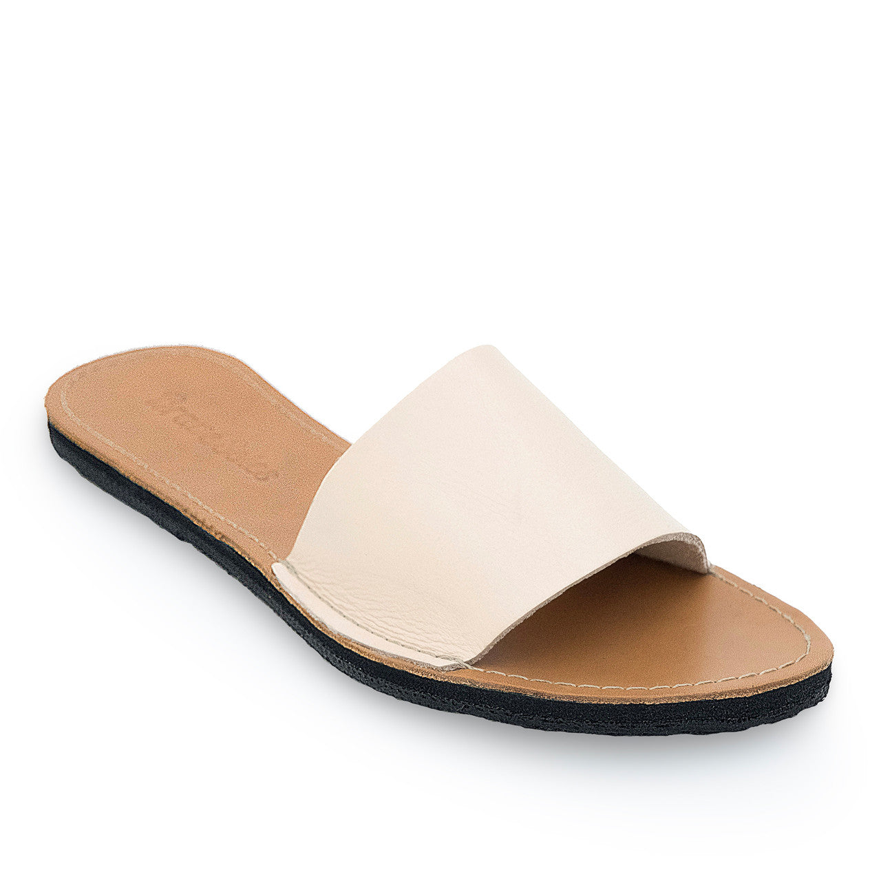 The Linda Leather Slide sandal with handcrafted white leather upper and upcycled tire sole, cushy EVA foam midsole, and secure ankle strap for comfort