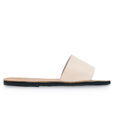 The Linda Leather Slide sandal with ethically sourced leather, cushy EVA foam mid-sole, hand-cut upcycled tire sole, and secure ankle strap for comfort