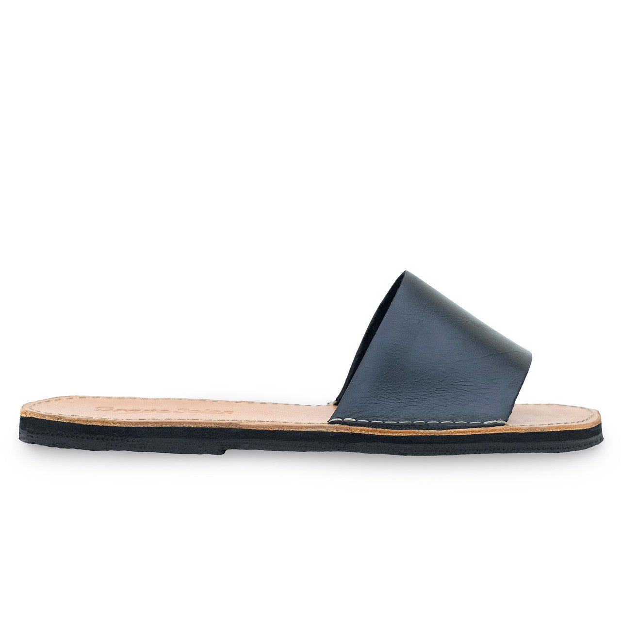 The Linda Leather Slide sandal in black, handcrafted leather with cushy EVA foam midsole and upcycled tire sole.