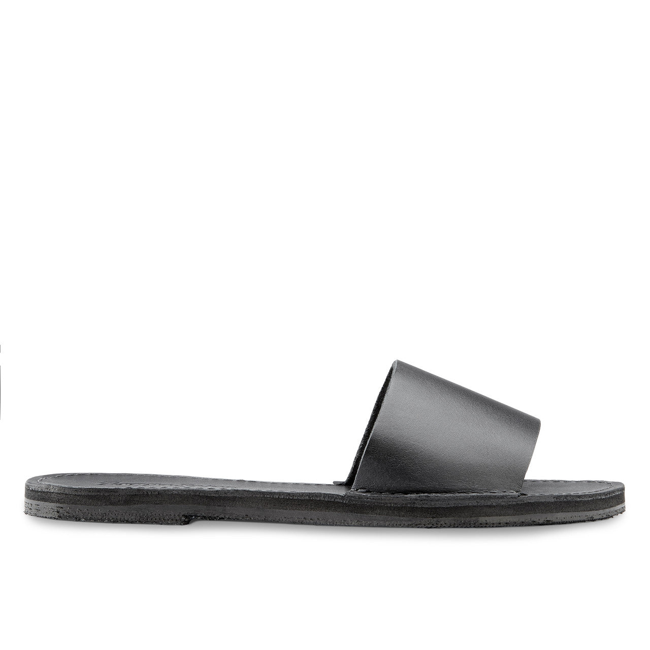 The Linda Leather Slide sandal in black, handcrafted ethical leather with cushy EVA foam midsole and upcycled tire sole.