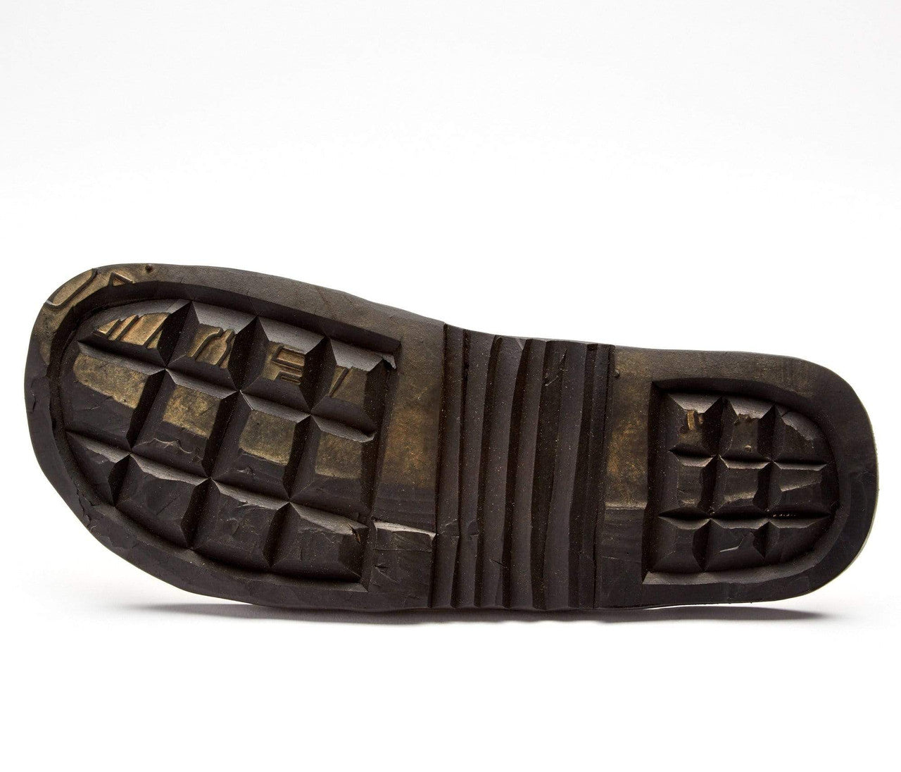 The sole of The Novio Men's Leather Flip Flop showing durable, hand-cut tire rubber tread pattern.