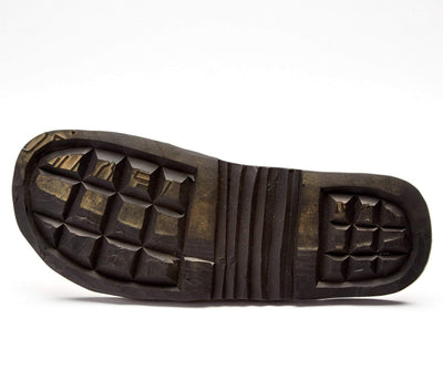 The sole of The Novio Men's Leather Flip Flop showing durable, hand-cut tire rubber tread pattern.