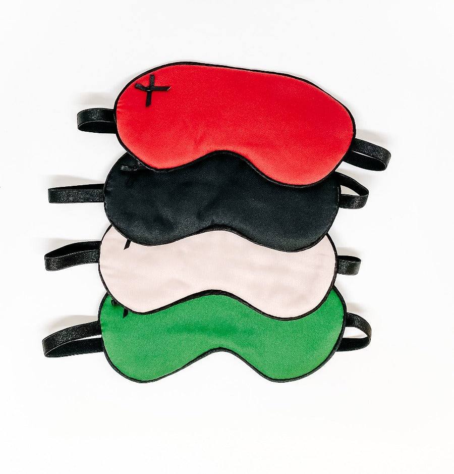stacked satin sleep masks in red black pink and green with elastic straps for comfortable fit