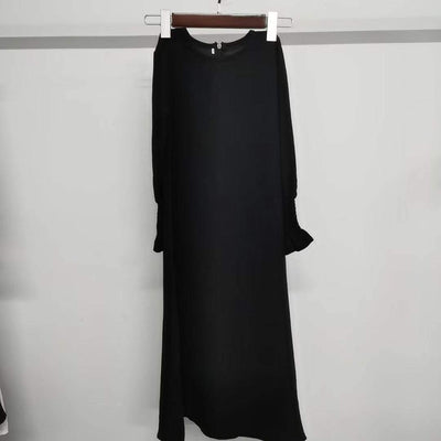 Black long sleeve round neck dress with wavy ruffled sleeves and solid color polyester fabric
