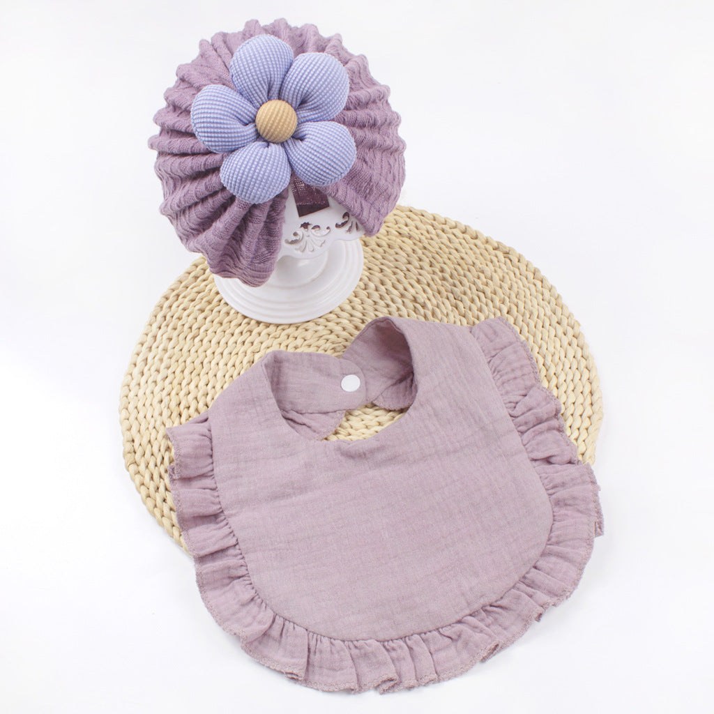 Organic muslin newborn baby hat with purple flower and matching soft pink frilly trim bib set