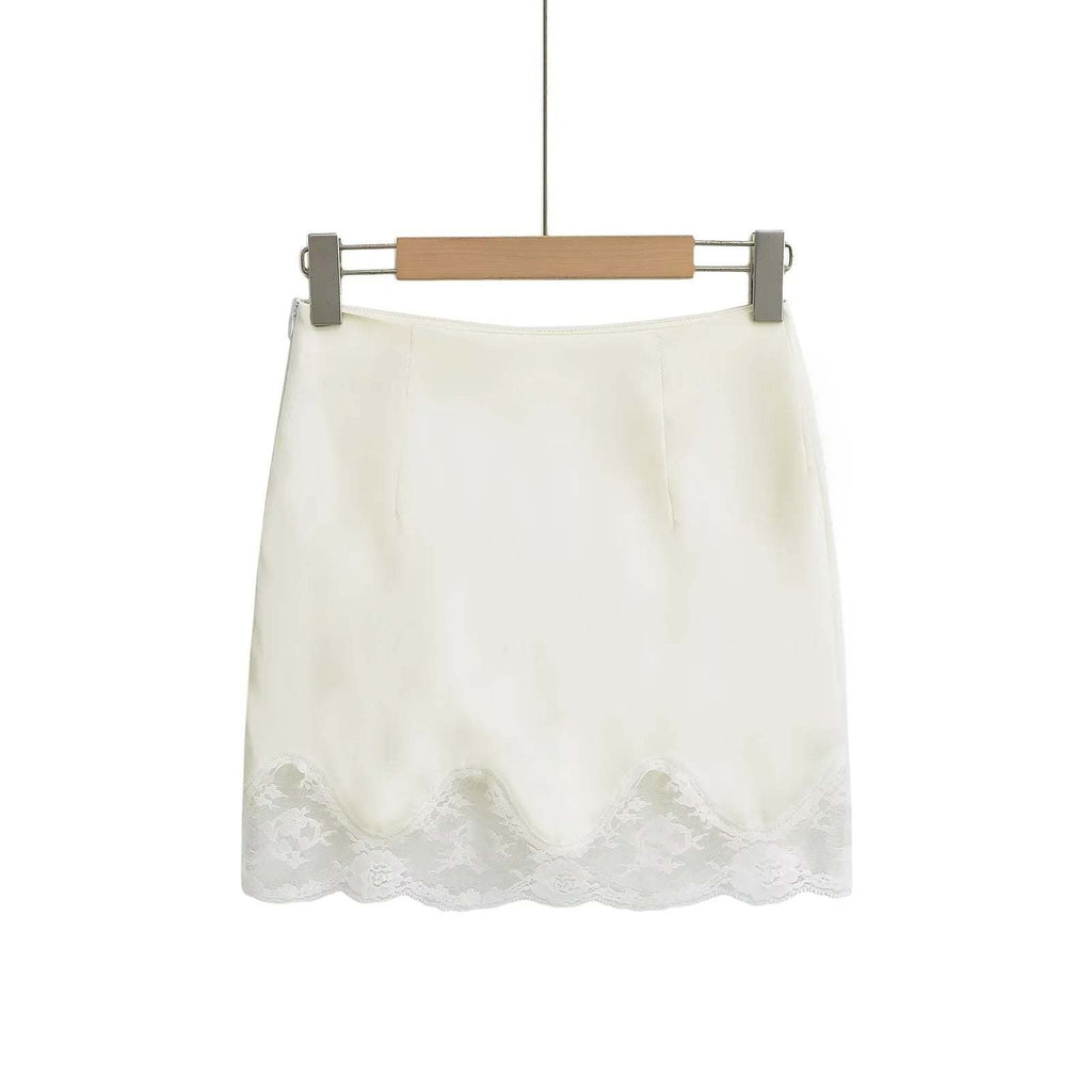 Beige women's mini sheath skirt with lace hem hanging on wooden hanger