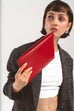 Woman holding red slim leather iPad sleeve with minimalist design and sleek protection